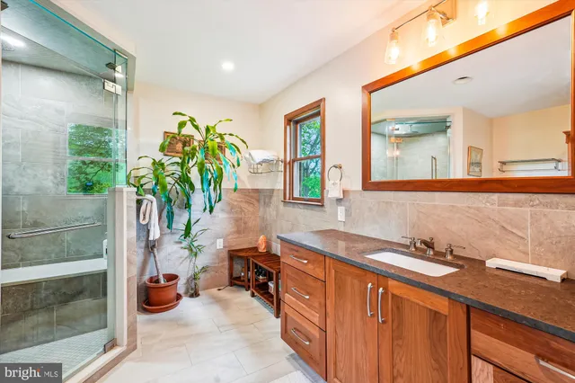 a bathroom with a shower sink and toilet