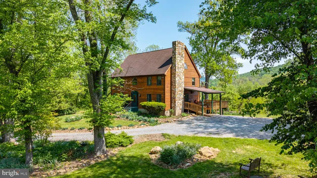 a view of a house with swimming pool next to a yard