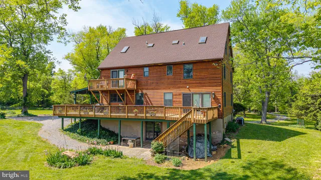 an aerial view of a house with swimming pool garden and patio