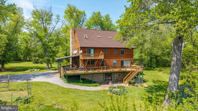 an aerial view of a house with swimming pool garden and patio