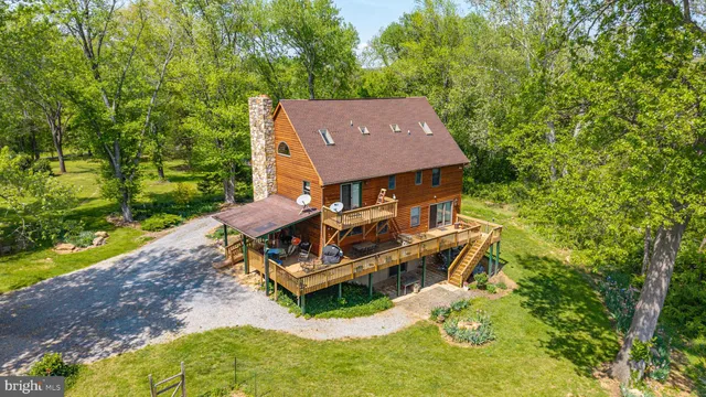 an aerial view of a house with swimming pool and garden