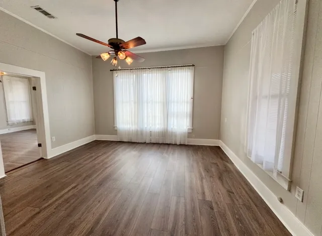 a view of a room with wooden floor window and a ceiling fan