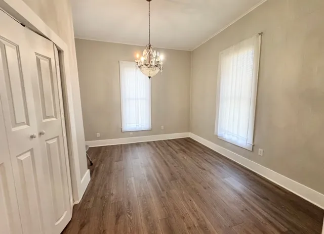 wooden floor in an empty room with a window