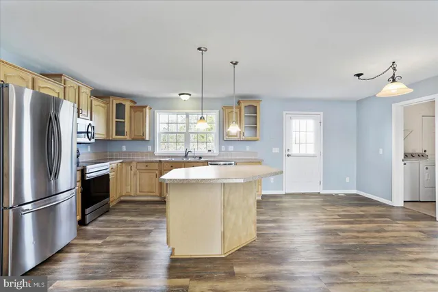 a kitchen with a refrigerator sink and cabinets