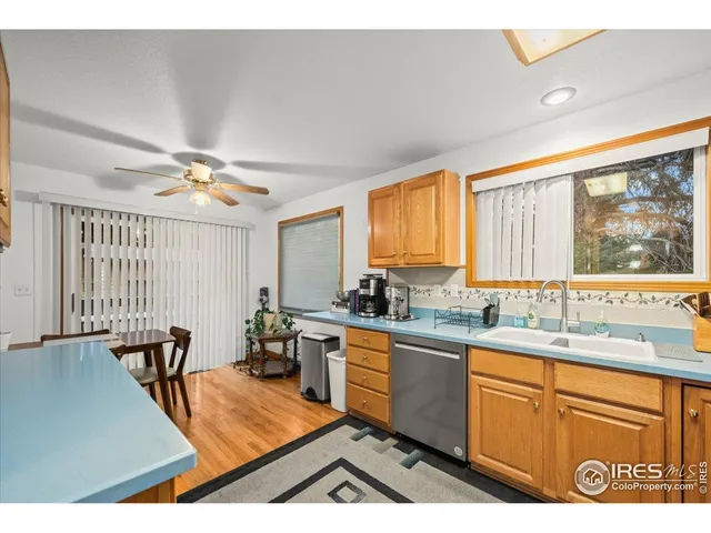 a kitchen with lots of counter top space and wooden floor