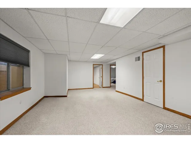 a view of a livingroom with an empty space and a window