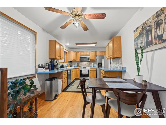a open dining room with kitchen island a table and chairs
