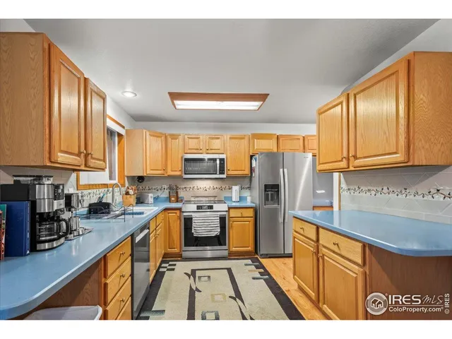 a kitchen with stainless steel appliances granite countertop a refrigerator stove microwave and sink