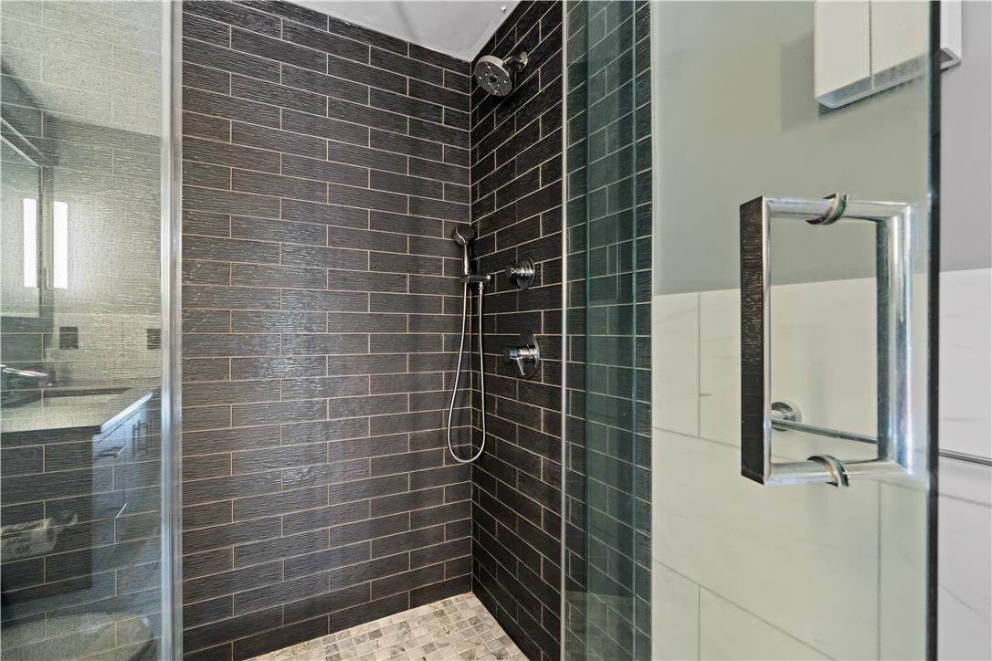 1506 Pleasant View Road Coopersburg, PA 18036 - Photo 72 of 97 A sleek, contemporary shower enclosure features dark subway tile walls and a mosaic floor.