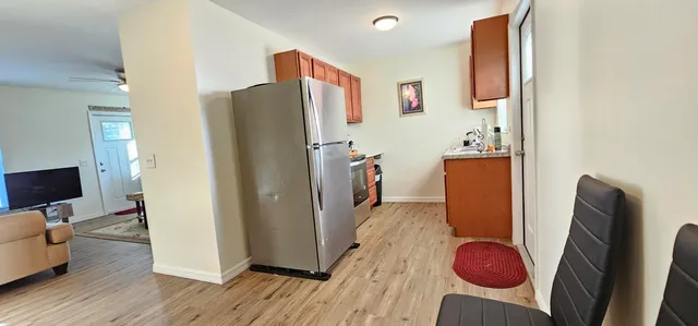 a view of kitchen with furniture and wooden floor