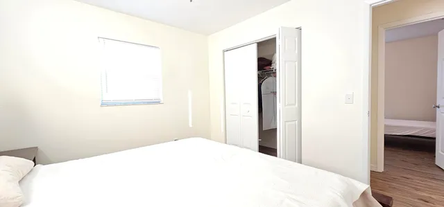 a bedroom with a bed and a view of bathroom