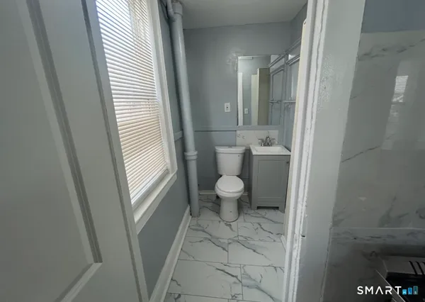 a bathroom with a toilet and a shower