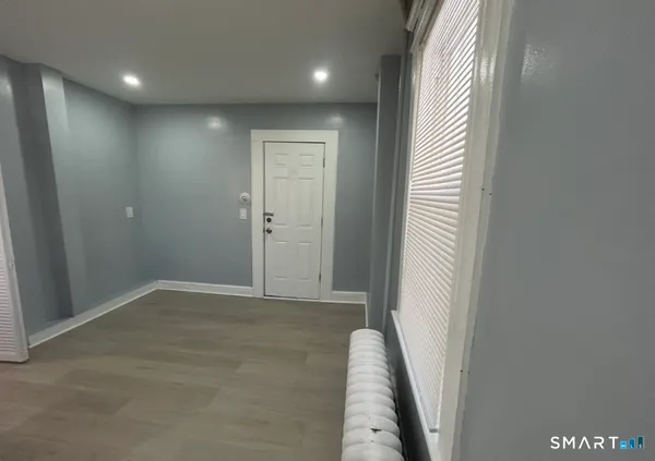 an entryway in a hall with a window