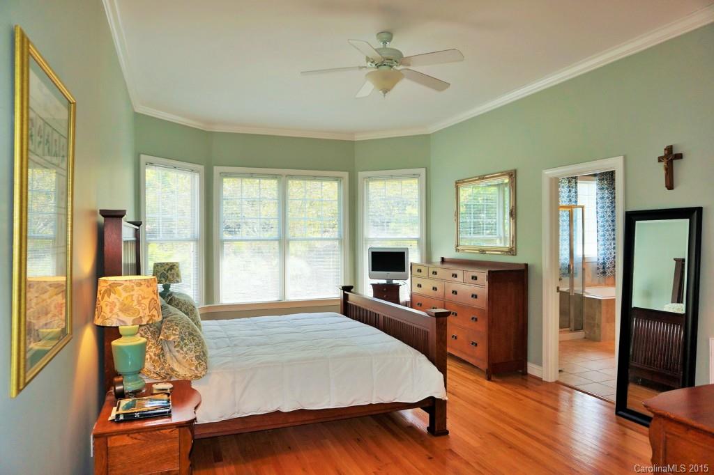 149 Mills Lane Fort Mill, SC 29708 - Photo 12 of 24 a bed room with a bed and a chandelier