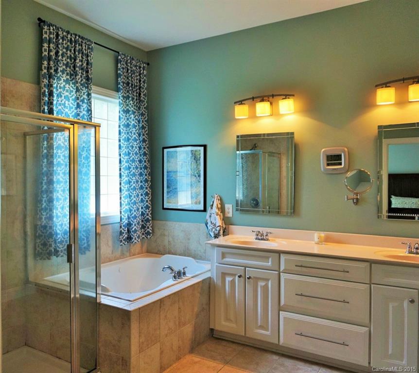 149 Mills Lane Fort Mill, SC 29708 - Photo 13 of 24 a bathroom with a sink a mirror and a bathtub