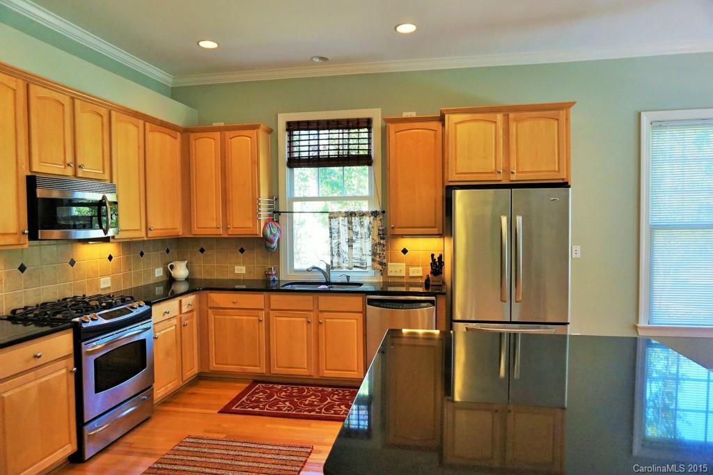 149 Mills Lane Fort Mill, SC 29708 - Photo 5 of 24 a kitchen with stainless steel appliances granite countertop a refrigerator a stove top oven a sink and dishwasher