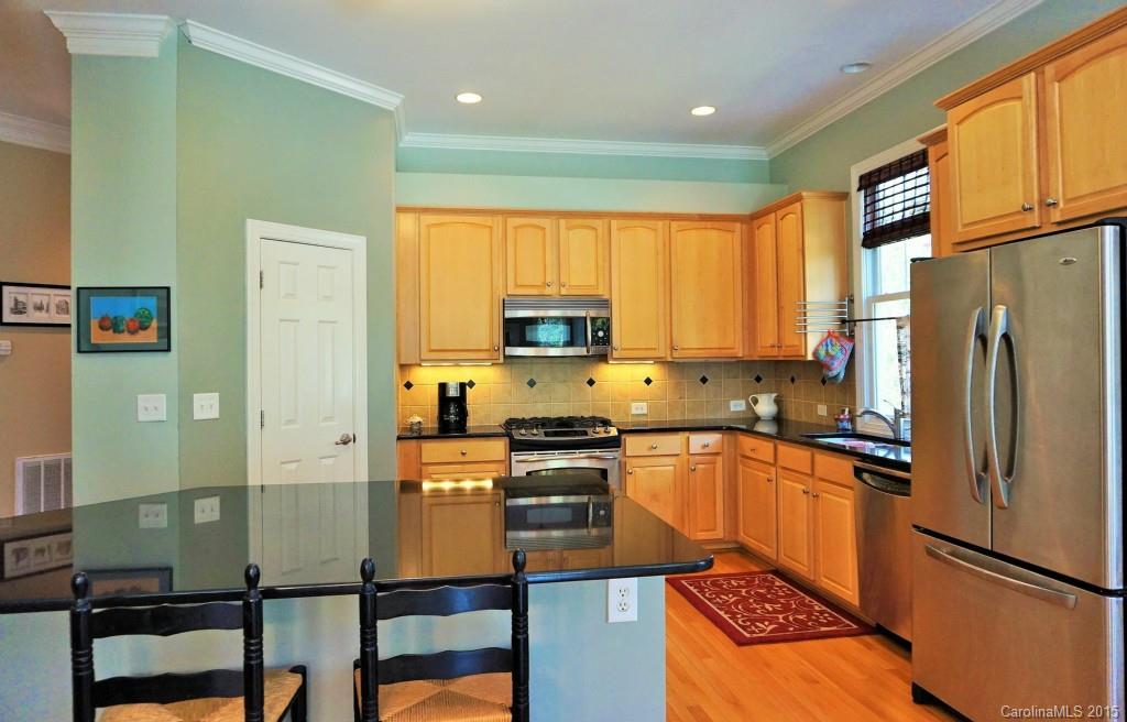 149 Mills Lane Fort Mill, SC 29708 - Photo 6 of 24 a kitchen with granite countertop a refrigerator stove top oven and sink