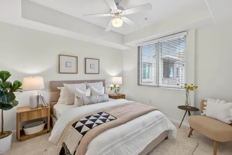 a bedroom with a bed and a chandelier