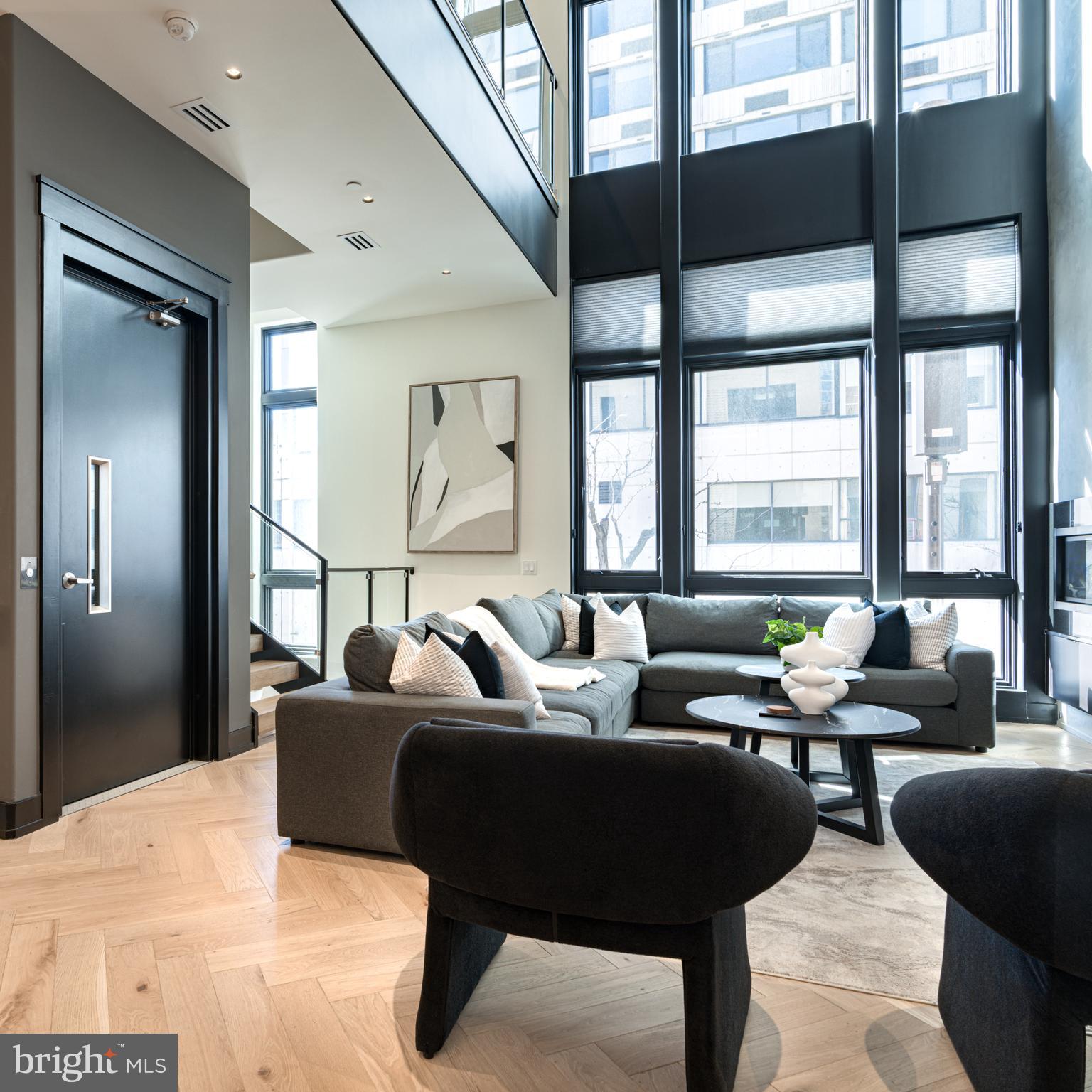 111 South 24th Street Philadelphia, PA 19103 - Photo 11 of 57 a living room with furniture and a large window