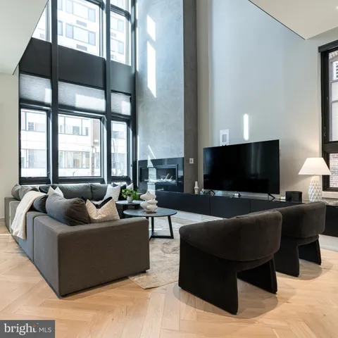 a living room with furniture and a floor to ceiling window