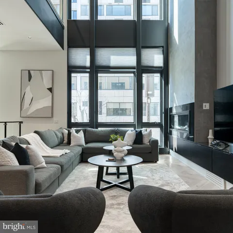 a living room with furniture and flowers