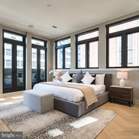 a bedroom with two beds and a large window