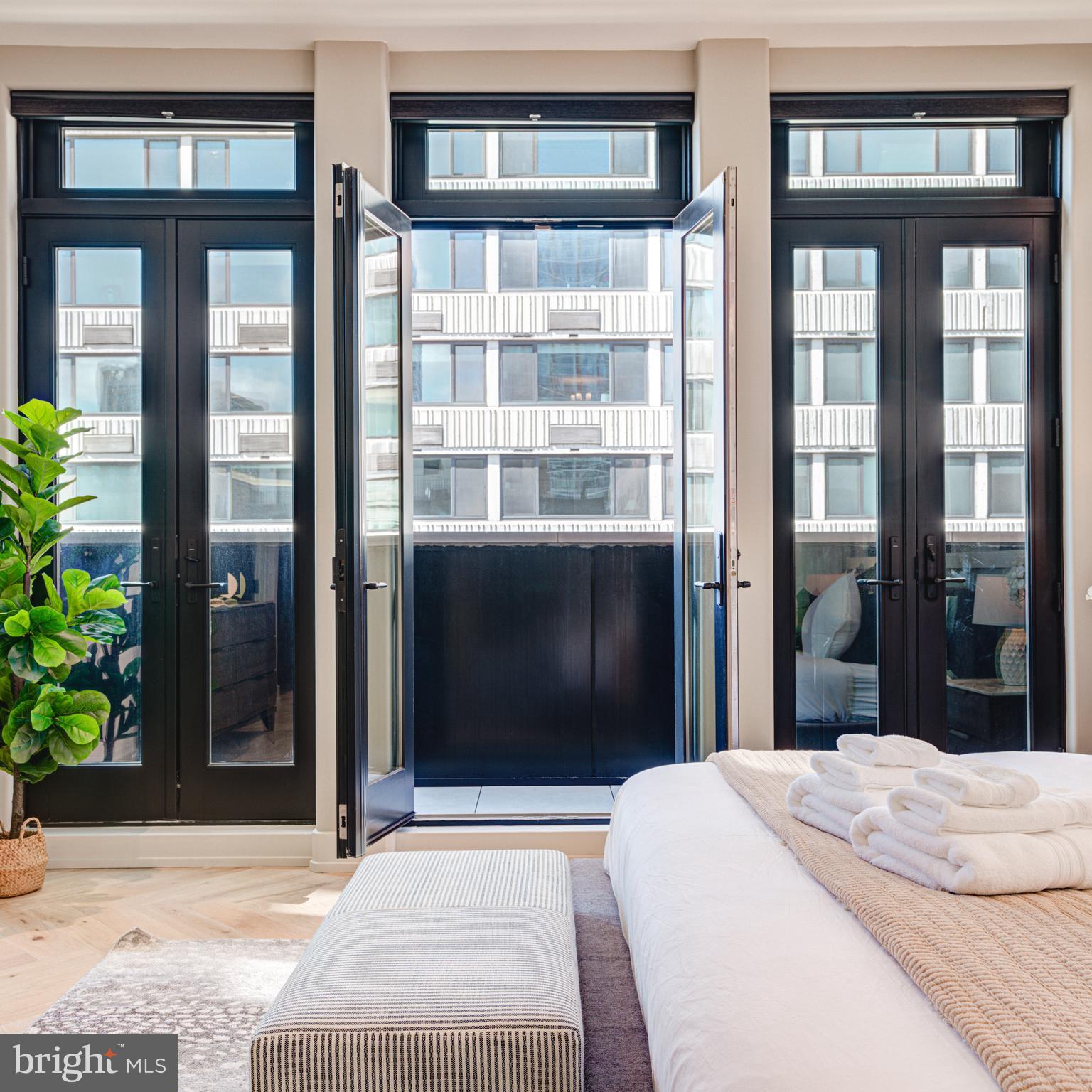 111 South 24th Street Philadelphia, PA 19103 - Photo 21 of 57 a bedroom with a bed and glass windows