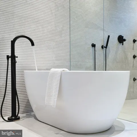 a bathroom with a bathtub and a shower