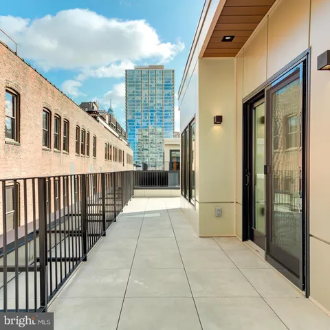 a view of a patio with table and chairs with wooden floor and fence