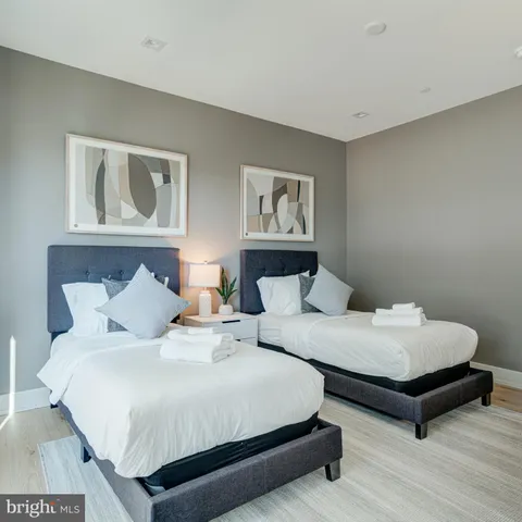 a bedroom with a bed and a lamp