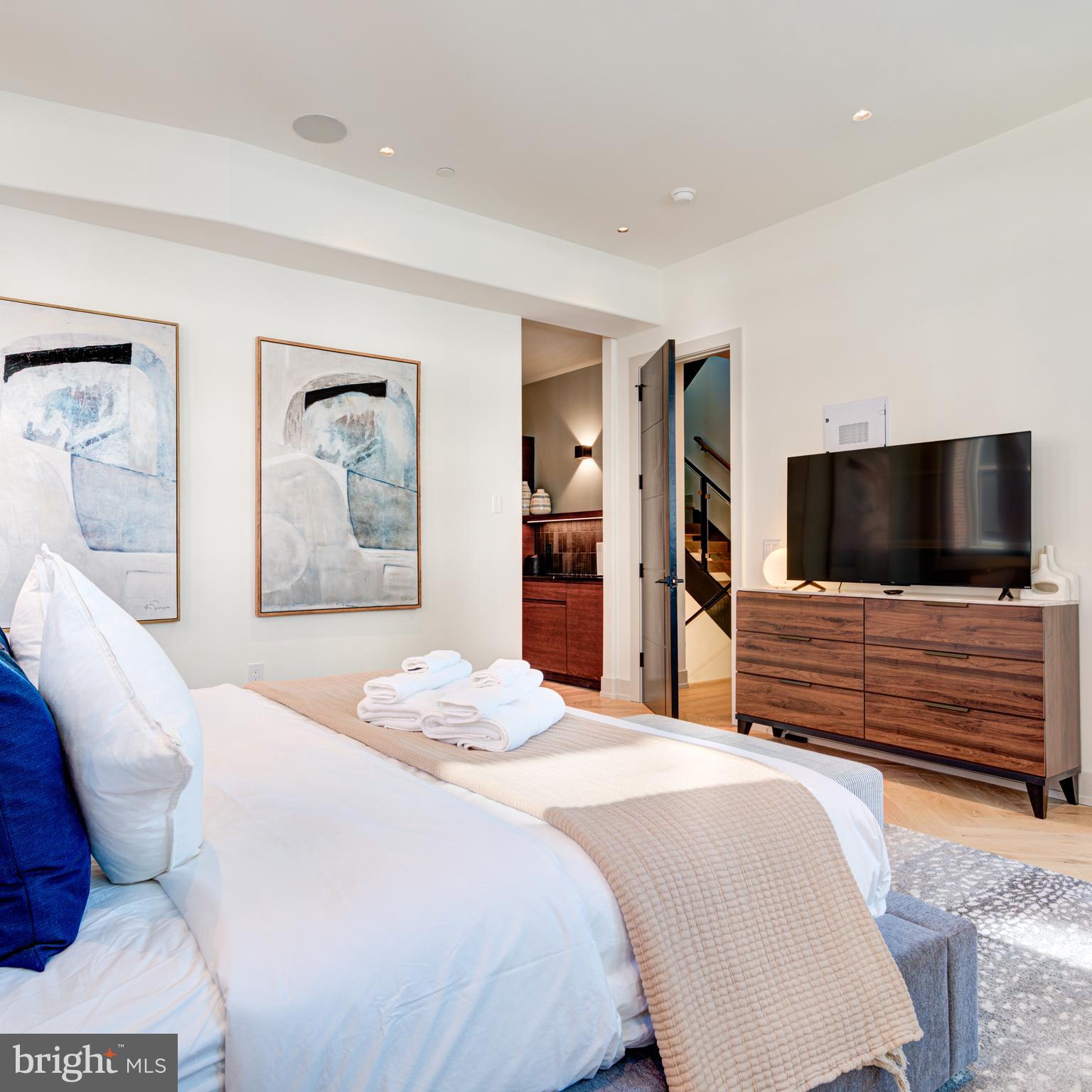 111 South 24th Street Philadelphia, PA 19103 - Photo 52 of 57 a bedroom with a bed and a flat screen tv