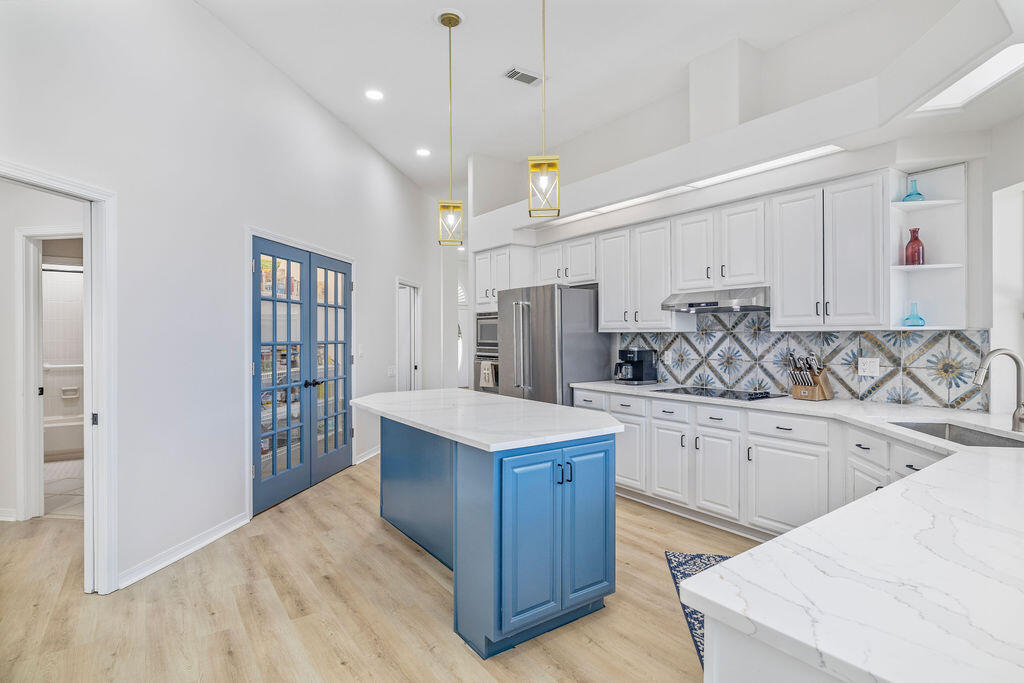 527 Indigo Loop Miramar Beach, FL 32550 - Photo 12 of 40 a kitchen with stainless steel appliances granite countertop a sink dishwasher stove and refrigerator
