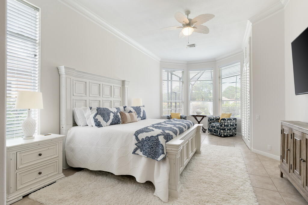 527 Indigo Loop Miramar Beach, FL 32550 - Photo 15 of 40 a spacious bedroom with a bed and a chandelier