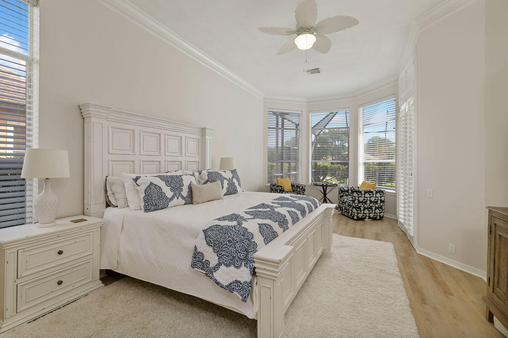 527 Indigo Loop Miramar Beach, FL 32550 - Photo 18 of 40 a spacious bedroom with a large bed and a chandelier fan