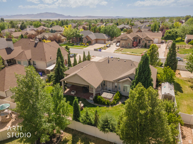2327 Bluff Ridge Drive Syracuse, UT 84075 - Photo 59 of 66 Expansive property featuring a covered patio, a manicured lawn, mature trees, and a storage shed