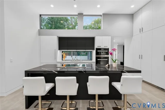 a kitchen with a dining table chairs and a refrigerator