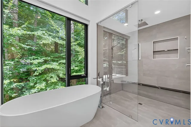 a bathroom with a bathtub and shower