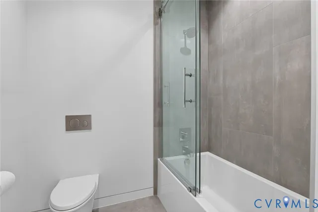 a bathroom with a toilet and bathtub