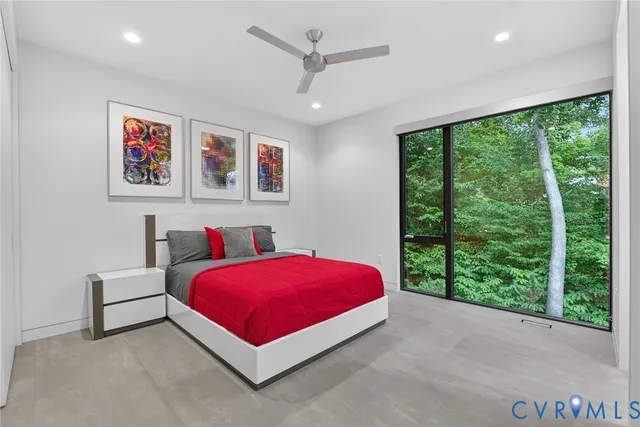 a bed room with a bed and a large window