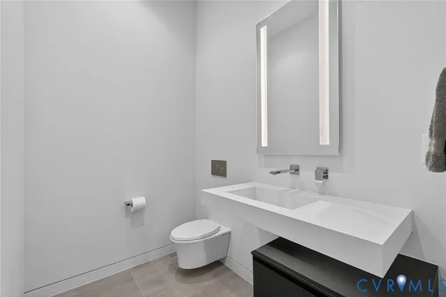 a bathroom with a sink a toilet and mirror