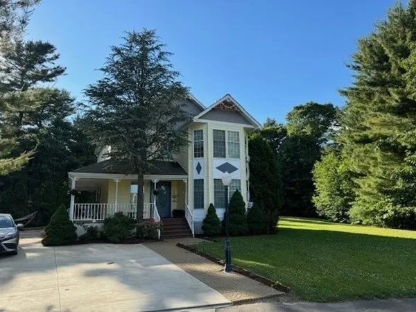 a front view of a house with a garden
