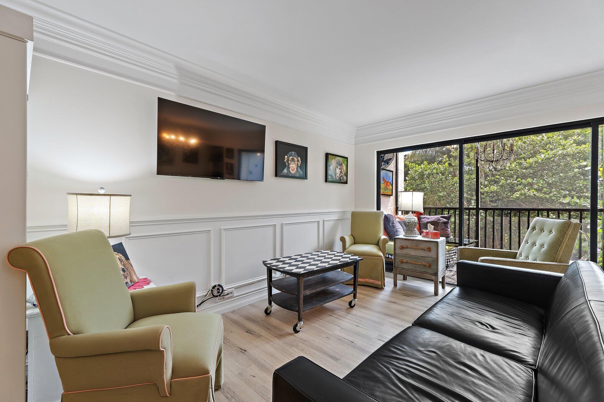 1605 Highway 1, Unit F202 Jupiter, FL 33477 - Photo 11 of 33 a living room with furniture and a flat screen tv