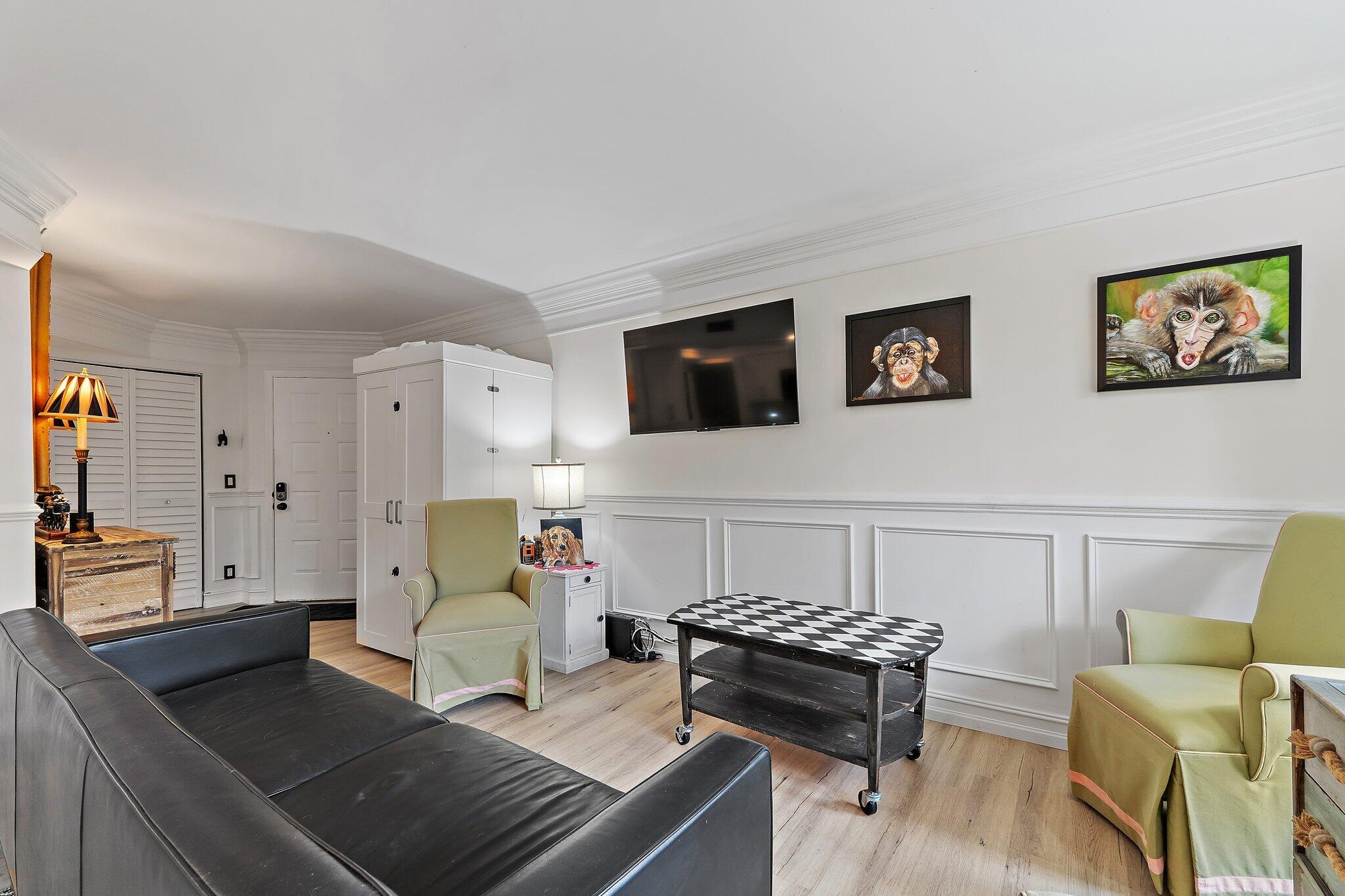1605 Highway 1, Unit F202 Jupiter, FL 33477 - Photo 12 of 33 a living room with furniture and wooden floor