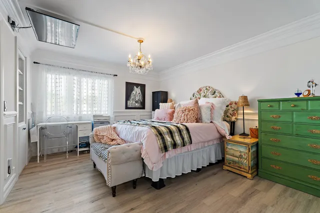 a spacious bedroom with a bed and a window