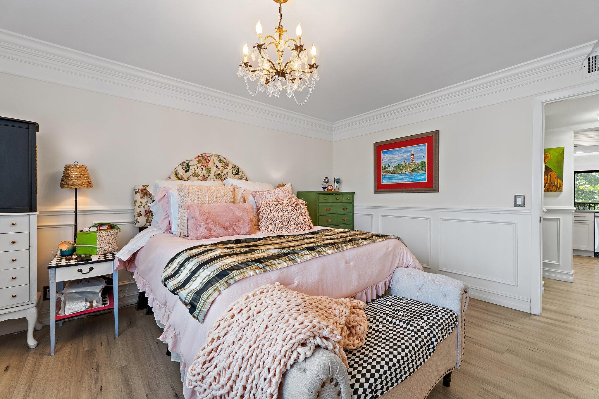 1605 Highway 1, Unit F202 Jupiter, FL 33477 - Photo 23 of 33 a bed room with a bed and a chandelier