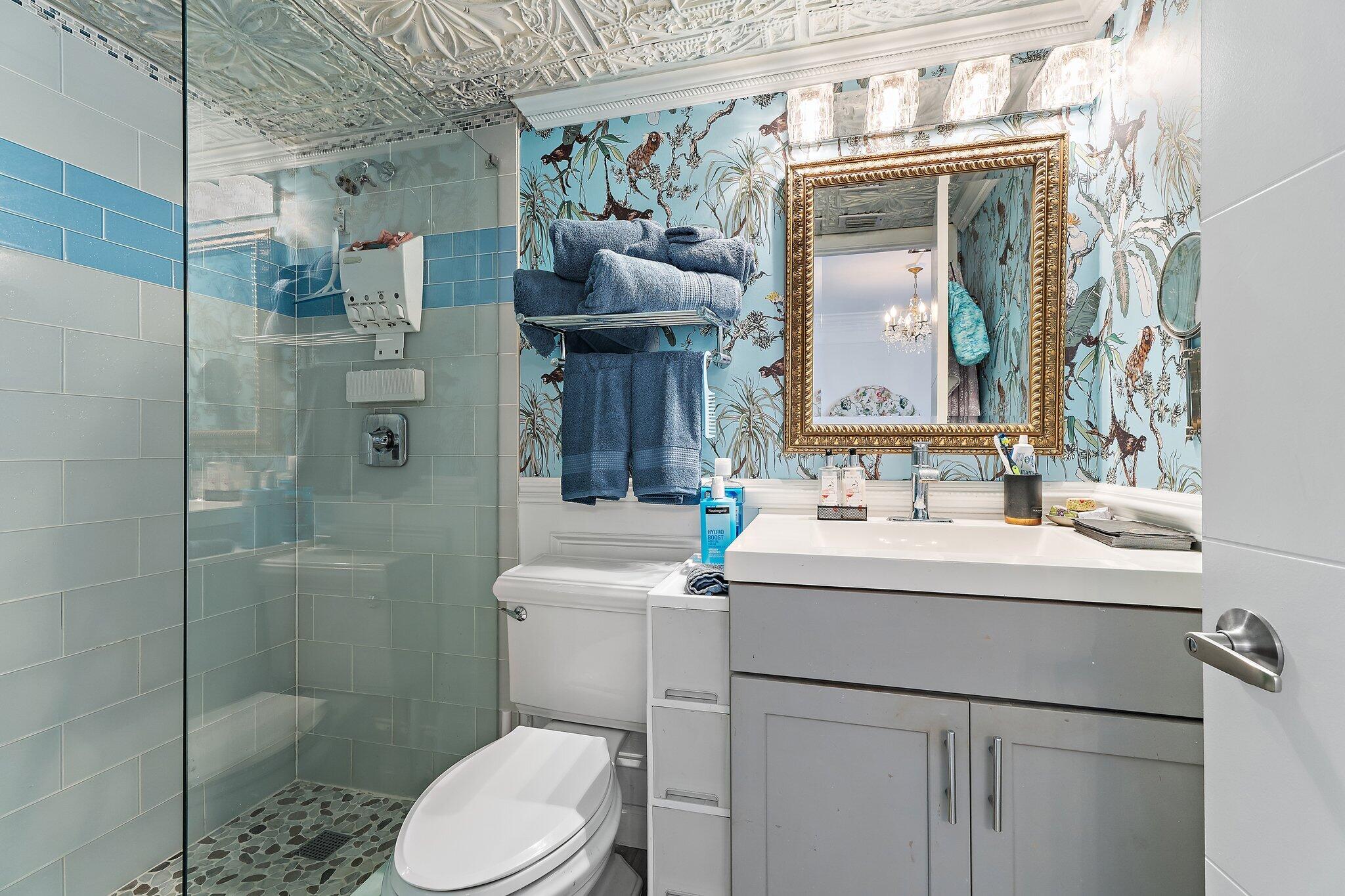 1605 Highway 1, Unit F202 Jupiter, FL 33477 - Photo 26 of 33 a bathroom with a sink toilet and shower