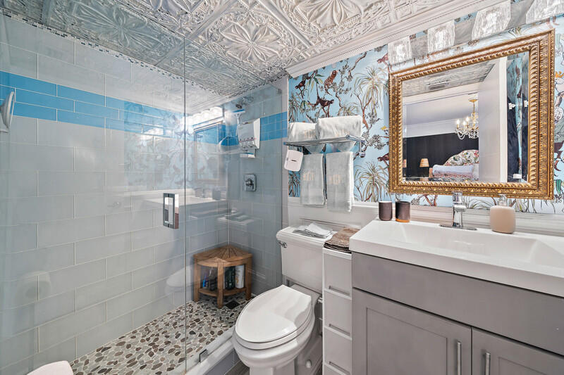 1605 Highway 1, Unit F202 Jupiter, FL 33477 - Photo 28 of 33 a bathroom with a sink toilet vanity and shower