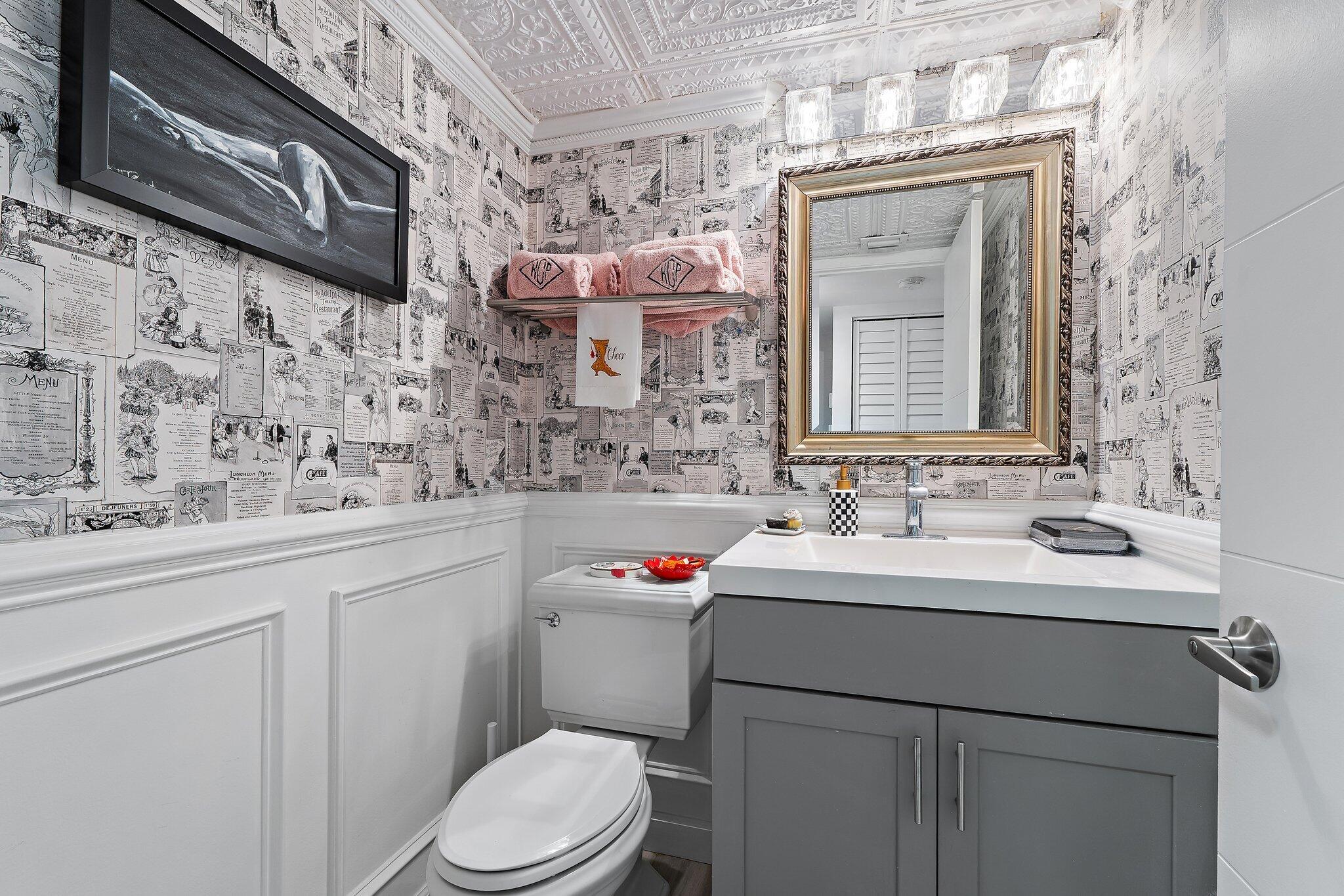 1605 Highway 1, Unit F202 Jupiter, FL 33477 - Photo 29 of 33 a bathroom with a sink toilet and mirror