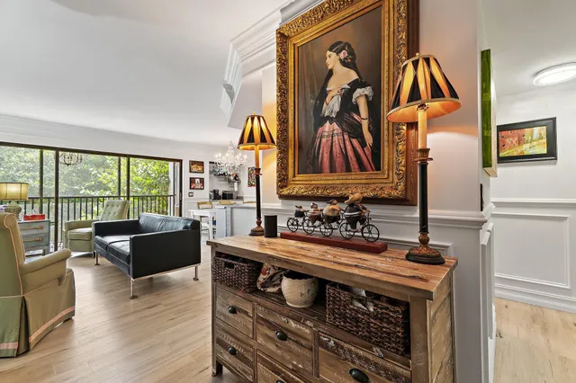 a living room with furniture and a floor to ceiling window