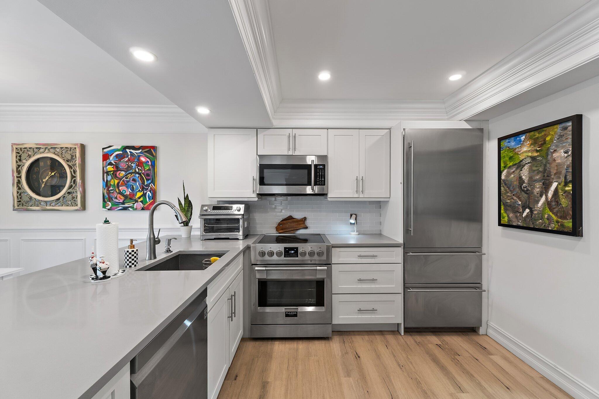 1605 Highway 1, Unit F202 Jupiter, FL 33477 - Photo 8 of 33 a kitchen with a refrigerator and a stove top oven
